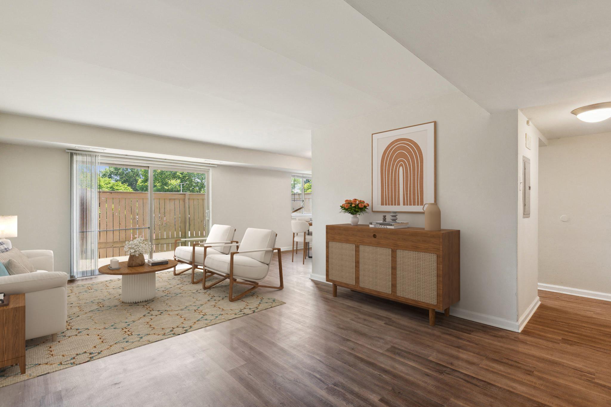 a living room with white furniture and a sliding glass door